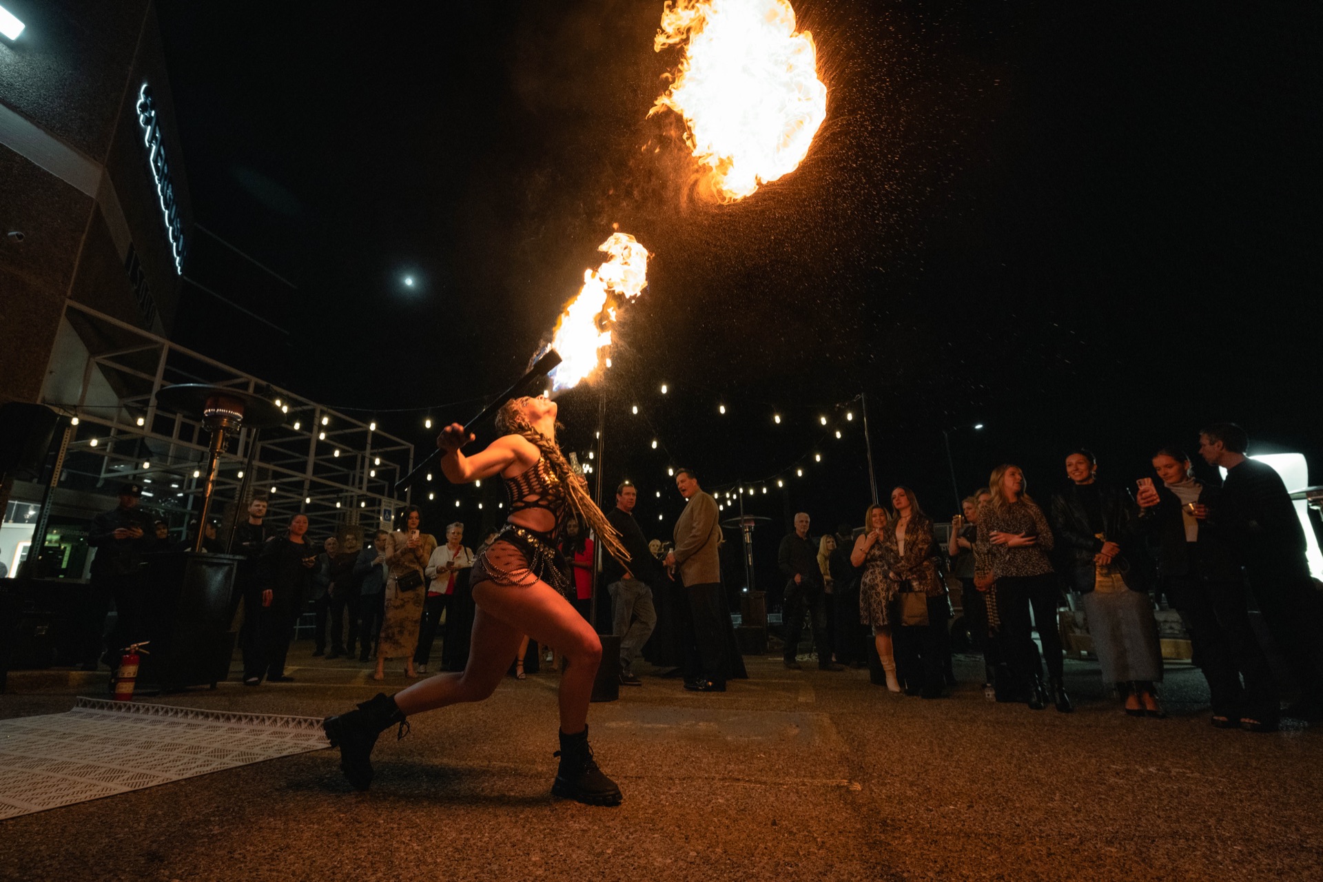 Performers with fire props at a private estate event